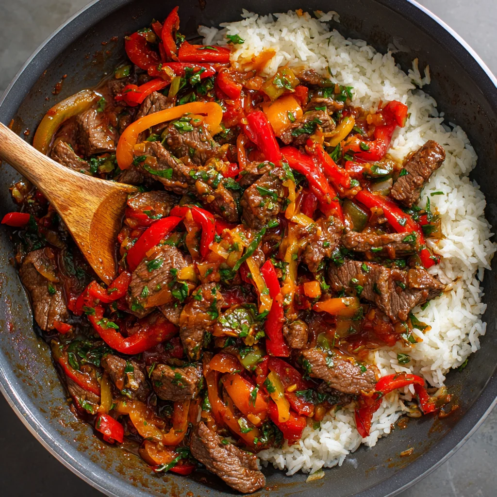Beef and Pepper Rice Bowl – Savory, Colorful, and Comfortingly Simple 4 Return the beef to the pan and toss with peppers and sauce until evenly coated