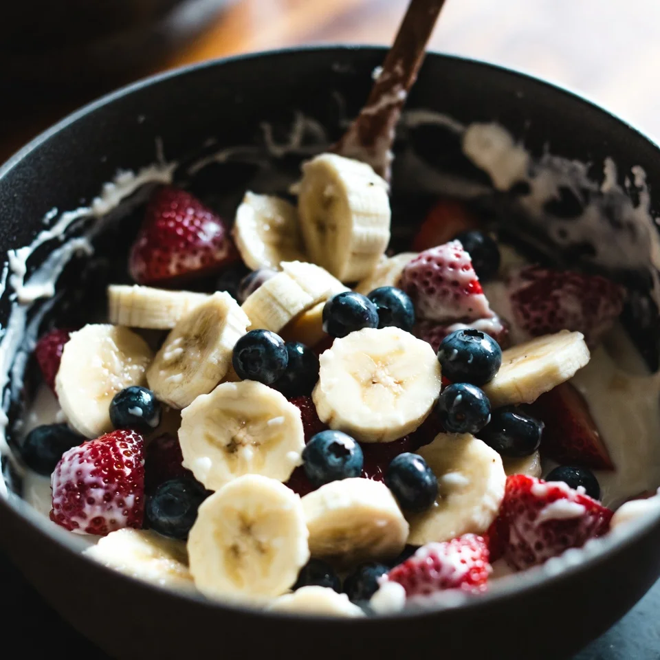 Mix all fruits in whisp cream for Bionico Bowls