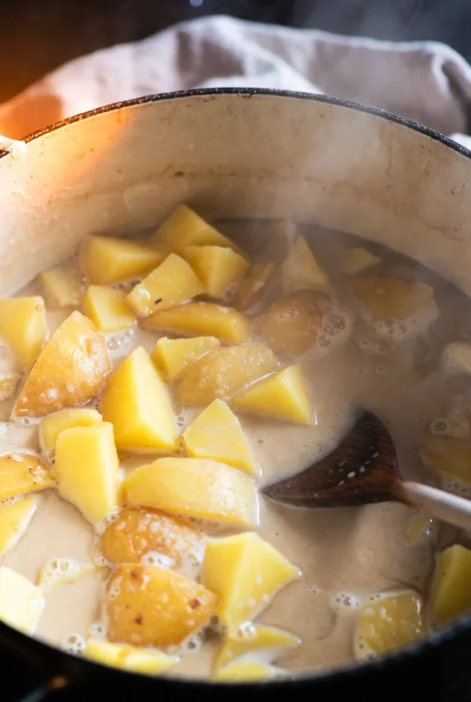 Peel and dice the potatoes into even pieces