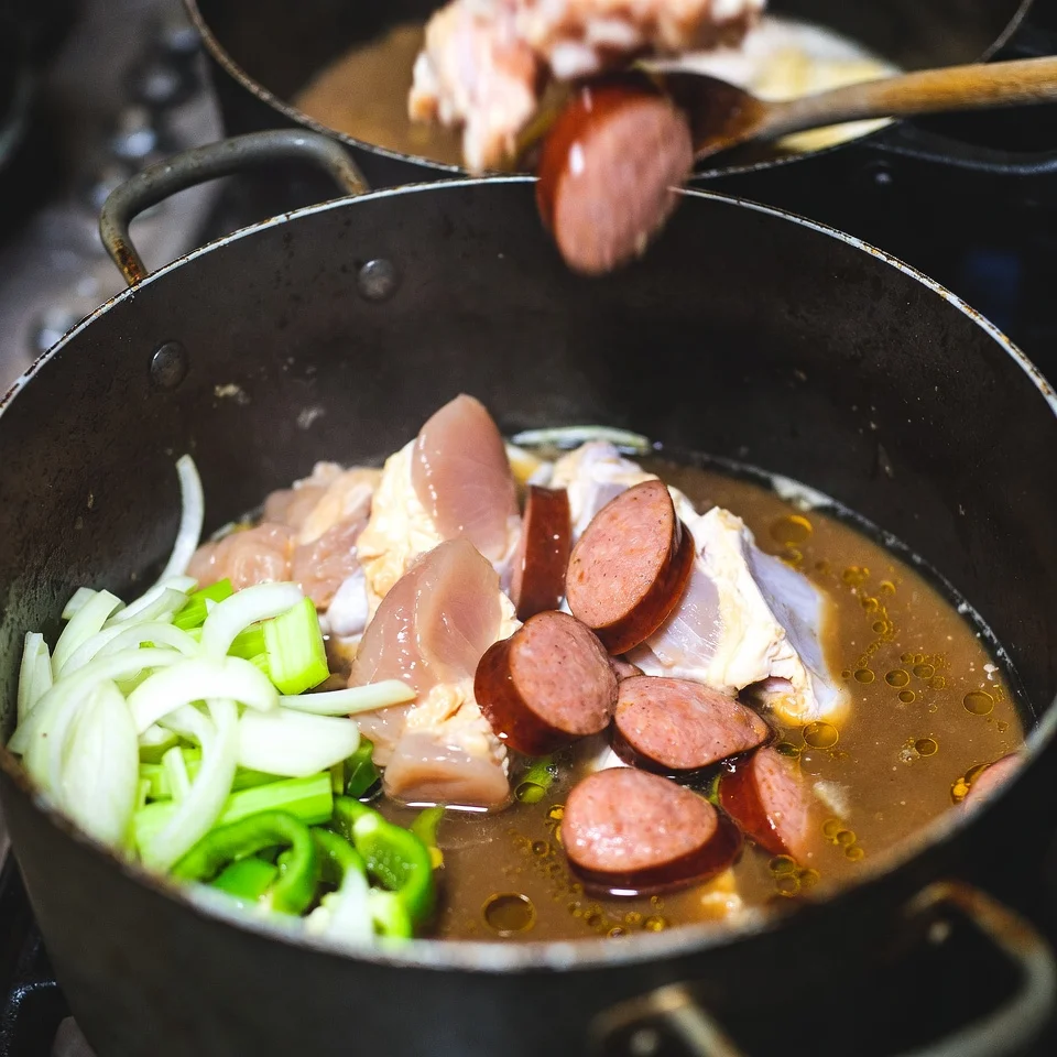 Adding chicken and andouille sausage to gumbo