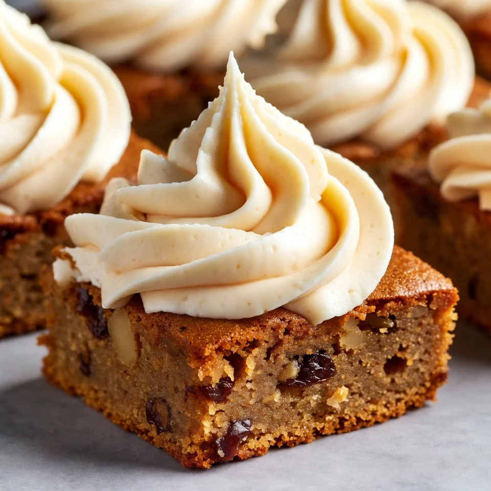 Spreading cream cheese frosting on carrot cake bars