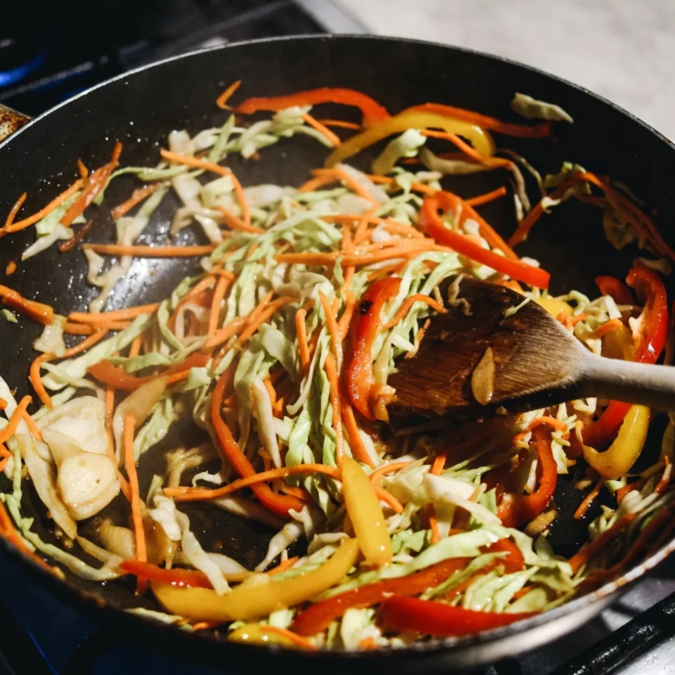 Delicious Potsticker Noodle Bowl Recipe 4 Sautéing coleslaw mix and fresh vegetables for noodle bowl