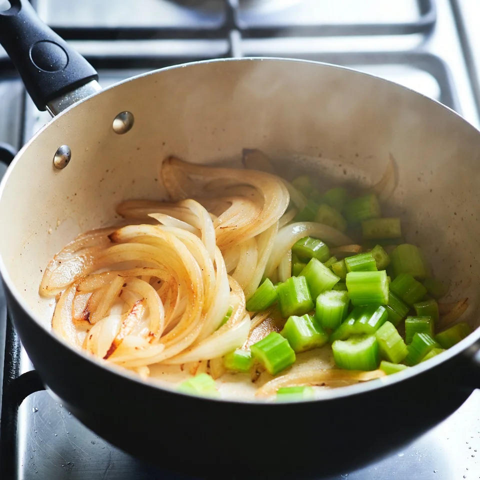 New England Clam Chowder Classic Creamy Seafood Chowder 3 Add onion and celery, cooking slowly until soft and fragrant