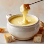 Creamy Cheese Fondue Recipe with bread dipped into melted cheese.