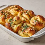 Golden Garlic Knots Recipe brushed with garlic butter and Parmesan.