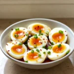 Soy Sauce Eggs Recipe sliced with jammy yolks and green onions.